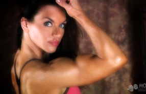 Athletic Tina Jo in pink showing off muscles
